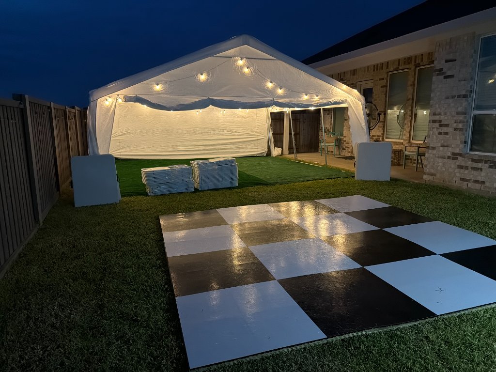Tent with Edison lights, turf & checkered dance floor — dusk magic 🌟