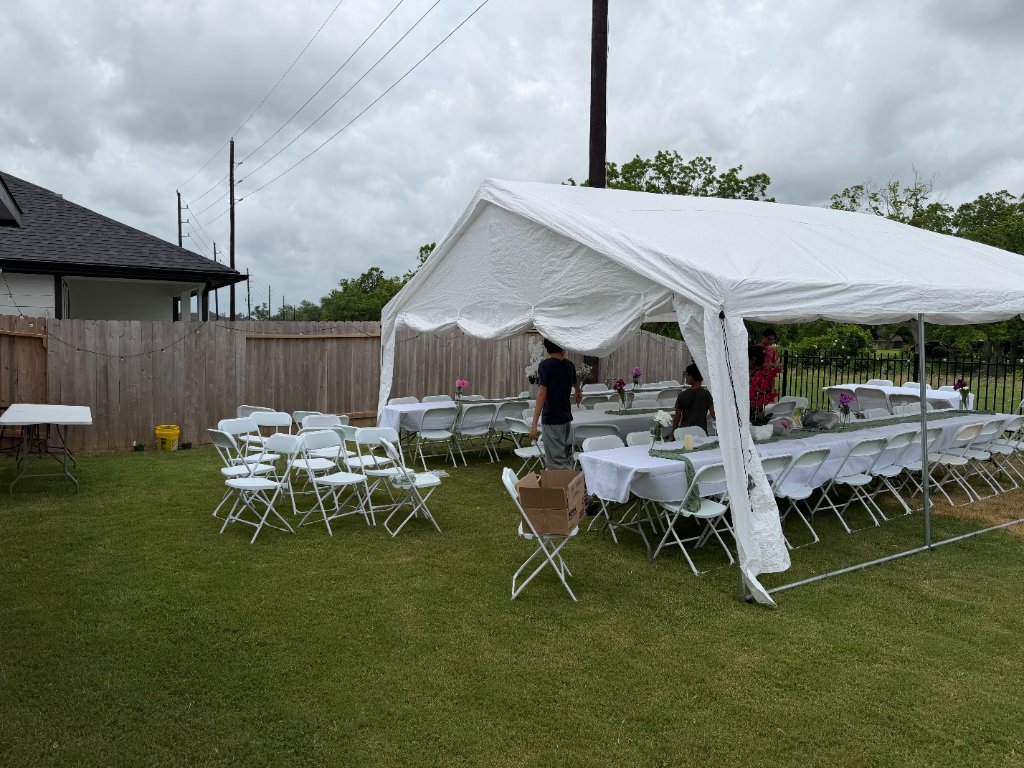 White tent with linen tables & chairs — overcast-day elegance 🌥️