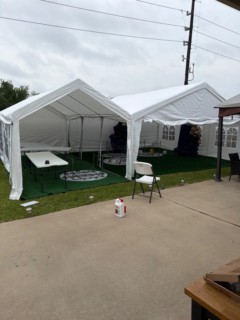 Twin white frame tents with turf & balloon columns inside 🌿