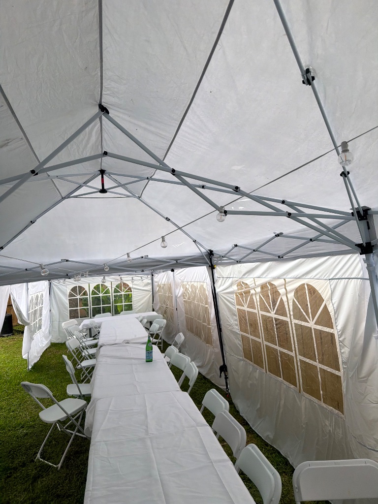Tent interior — long white linens & warm bistro ambiance 🌟