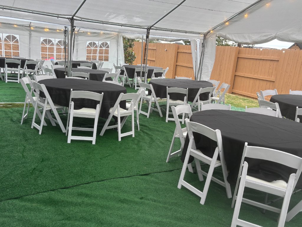 Tent with turf, black linen round tables & white chairs ✨