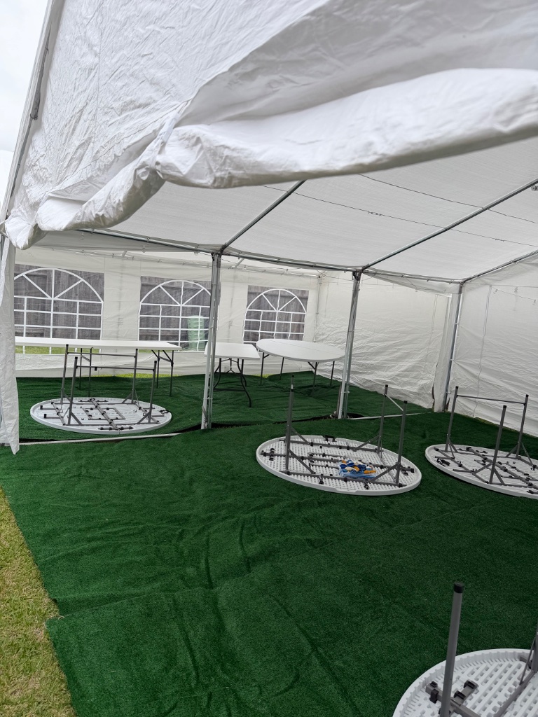 Tent with velvet turf & round tables — grand event setup 🌿