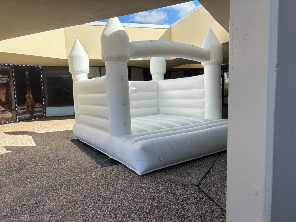 White bounce castle — covered patio, alternate angle 🏰