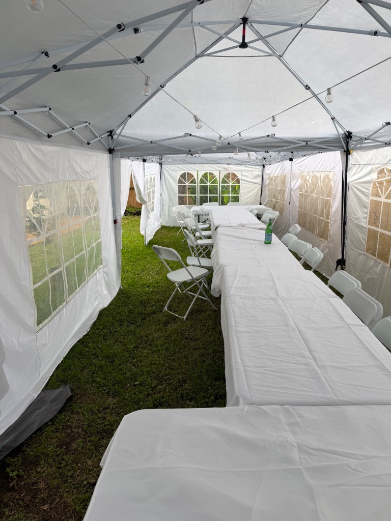 Tent interior — white linen banquet setup, party-perfect ✨