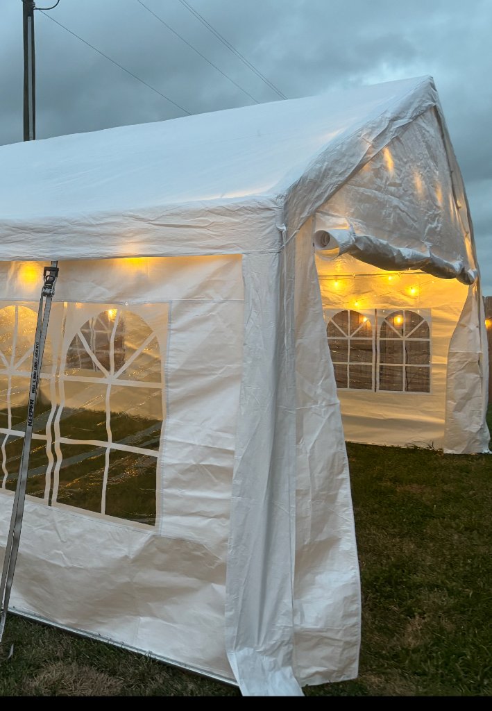 Draped white tent with cocktail tables — upscale affair 🥂