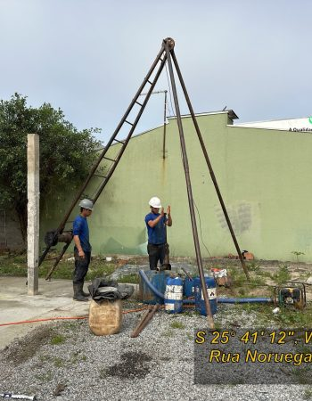 Equipe operando equipamento de sondagem SPT com tripé em quintal