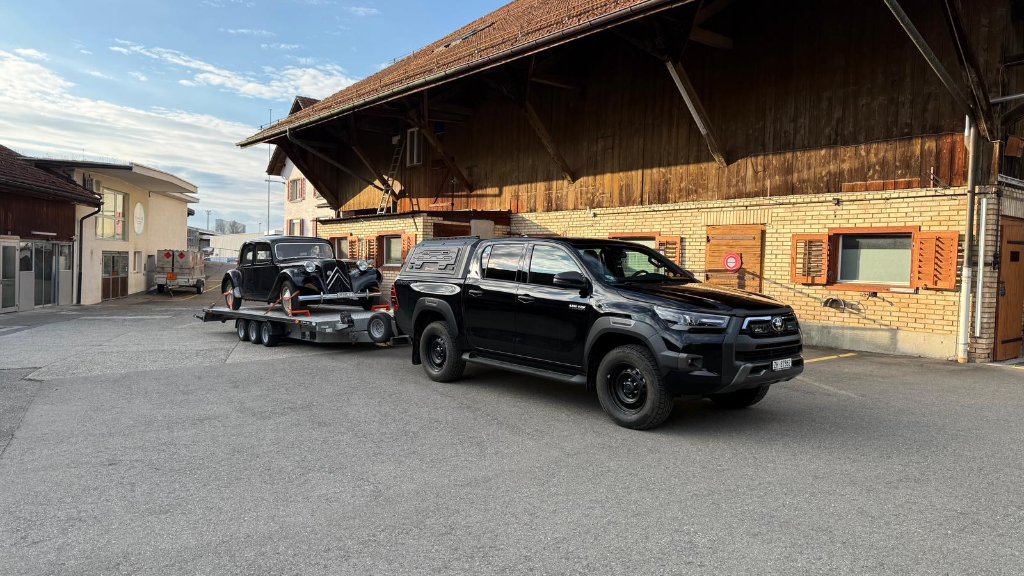 Toyota Hilux mit Anhänger und Citroën Traction beim Transport