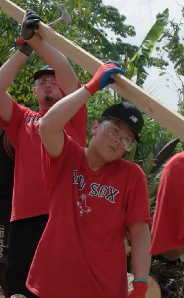 Two players lifting a wooden beam