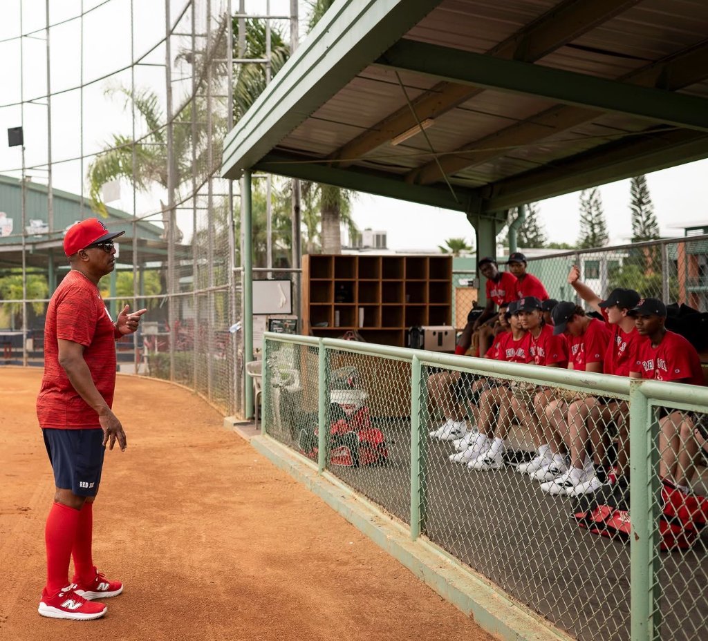 Coach instructing players in the dugout