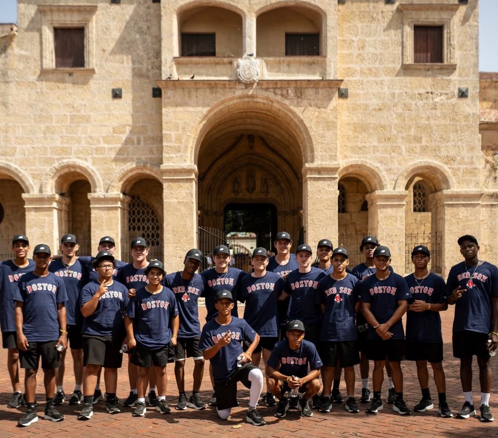 Team in Boston shirts at historic stone building