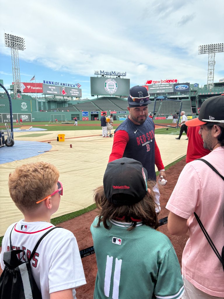 Gabe with a Red Sox player at Fenway Park