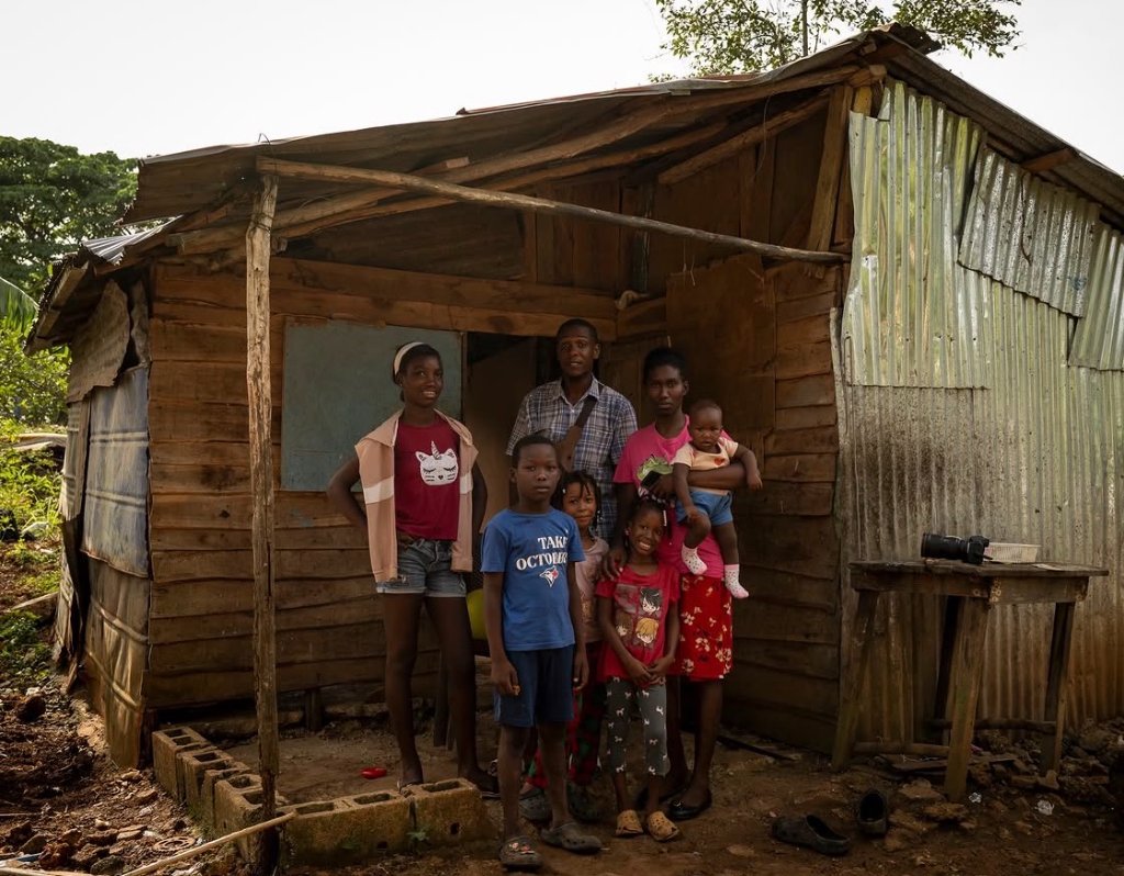 Local family in front of their home