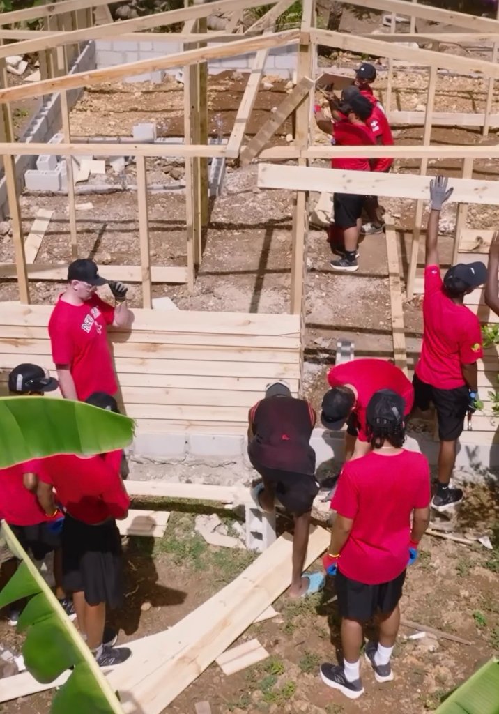 Team building a wood-frame house