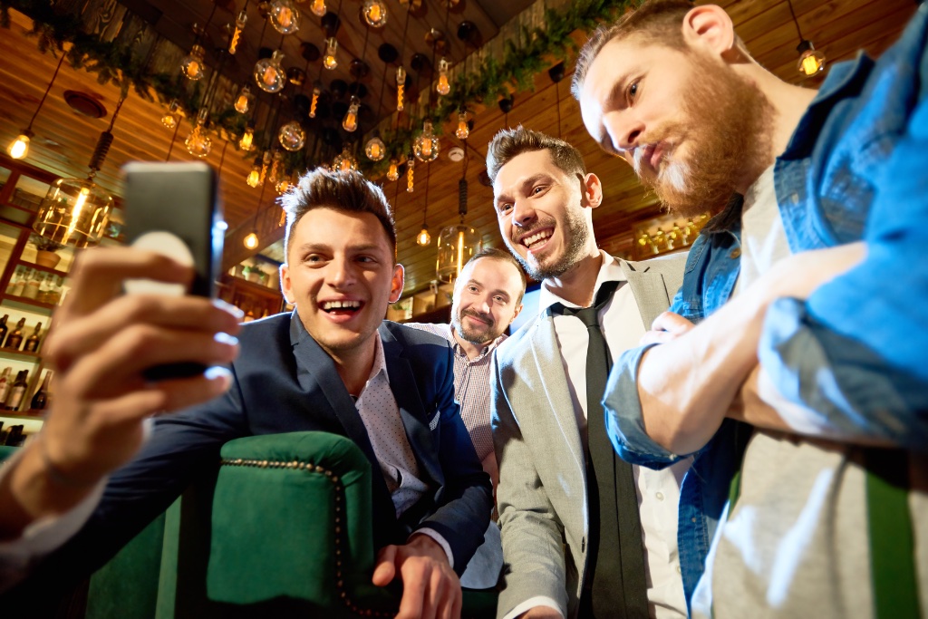 Group of men taking a selfie and capturing a momentous event
