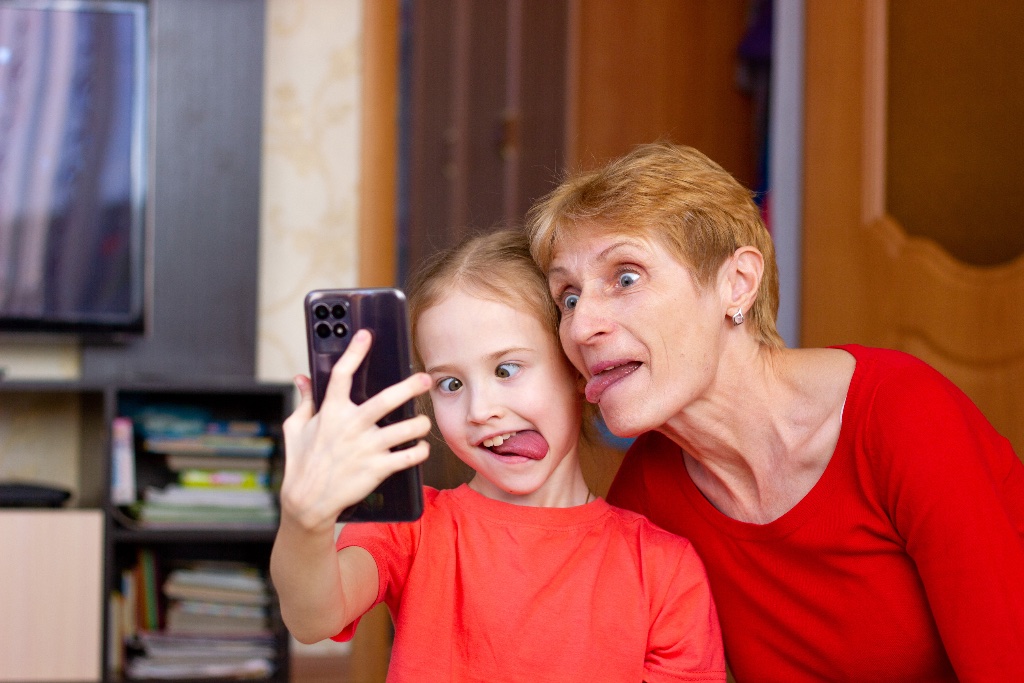 Grandmother and grandchild taking a funny selfie together