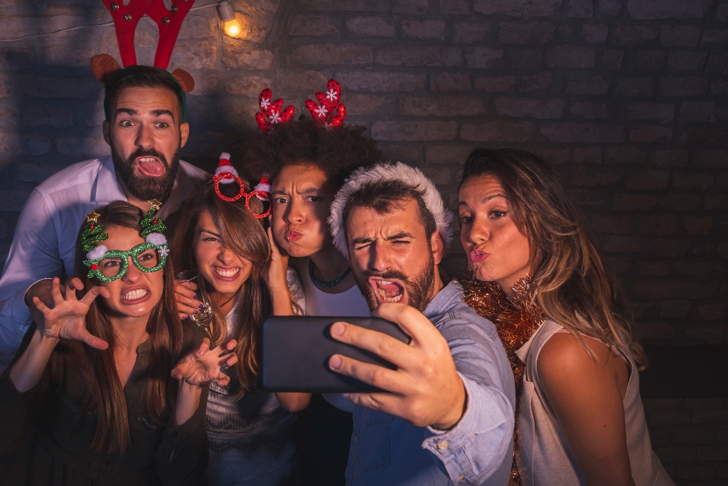 Group of friends taking a crazy selfie at a party