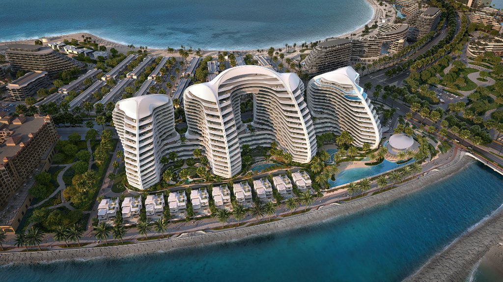 Vue aérienne en plongée du complexe résidentiel Oystra, montrant les bâtiments courbes, piscines, jardins paysagers et plage privée.