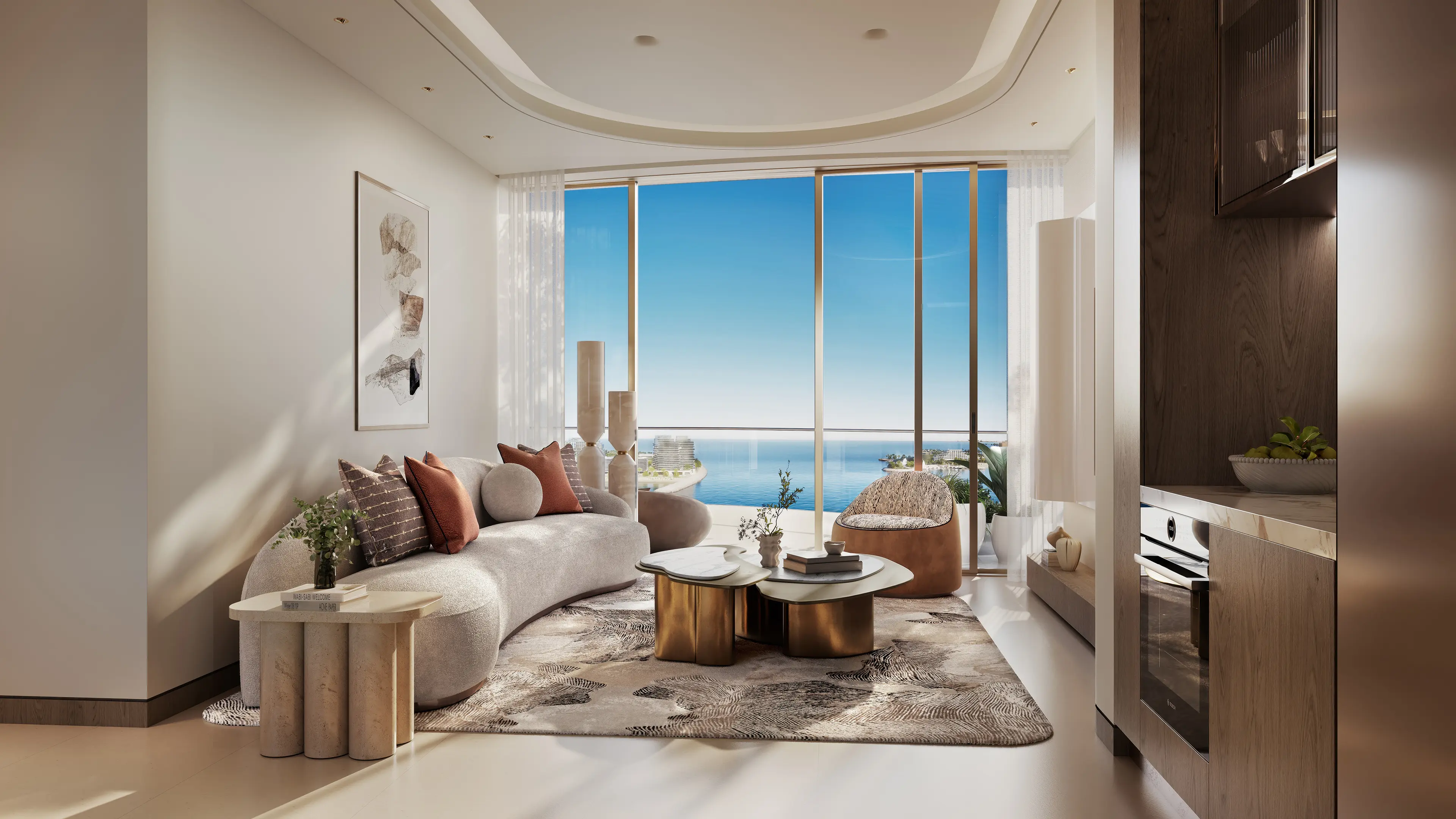 Salon d'appartement 1 chambre Oystra by Richmind avec baie vitrée panoramique sur l'océan, canapé courbe crème et tables basses en marbre.