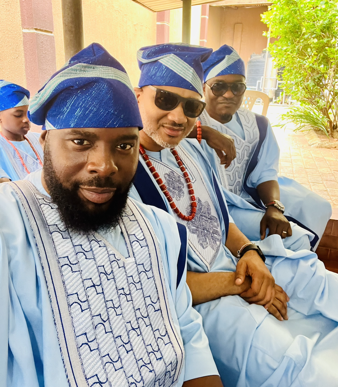 Three men in matching sky-blue agbada