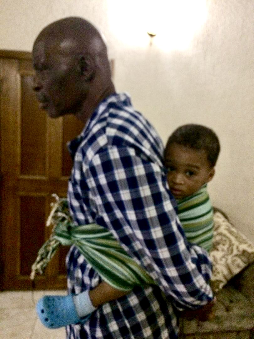 Keji Giwa carrying a child