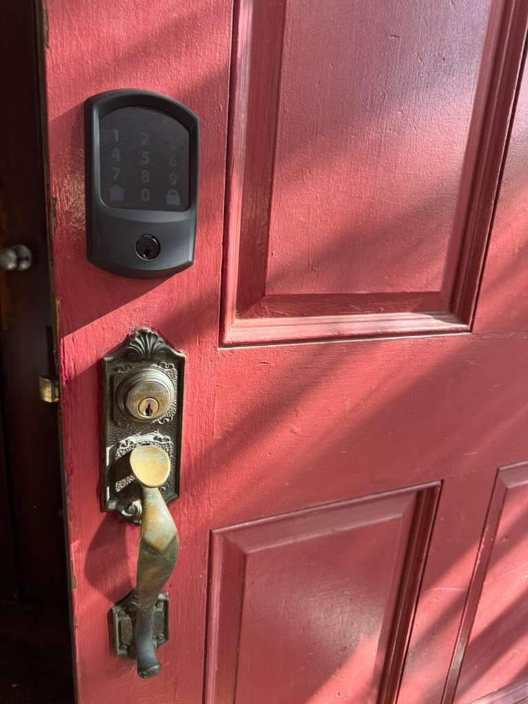 Completed smart lock with keypad installed on a residential door