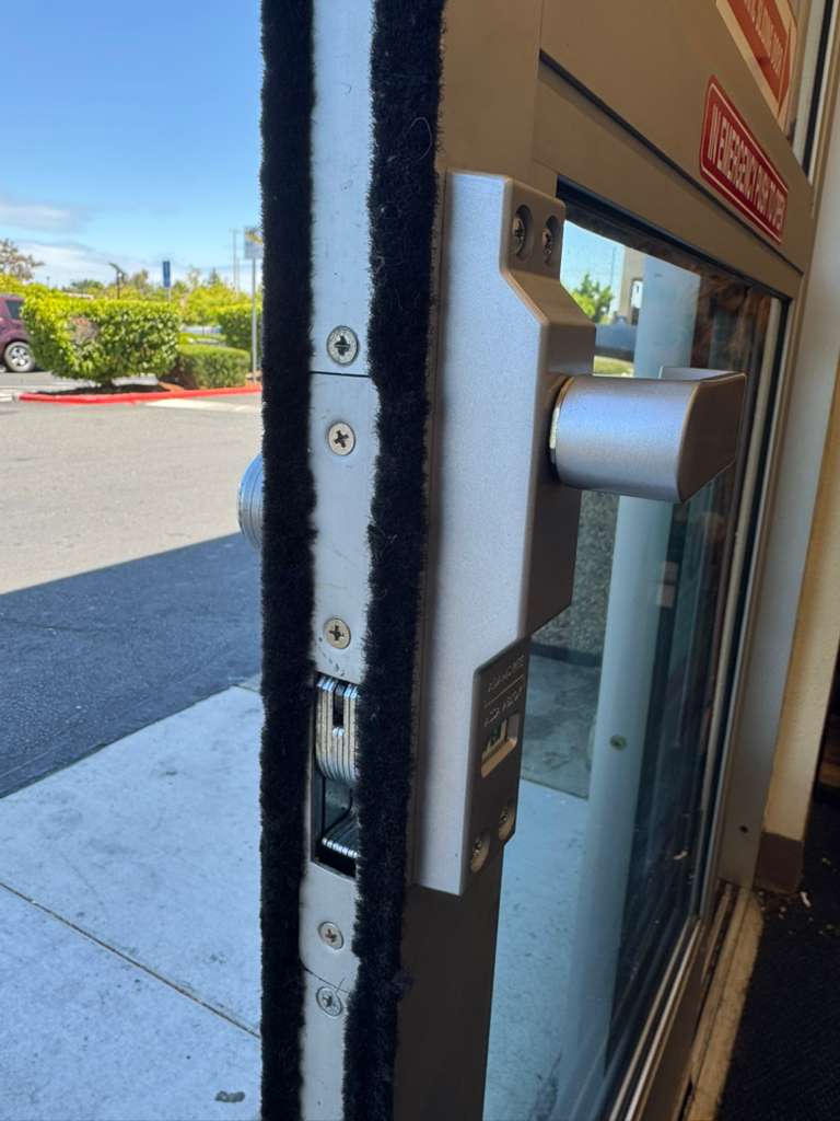 Commercial storefront door edge with lock housing installed