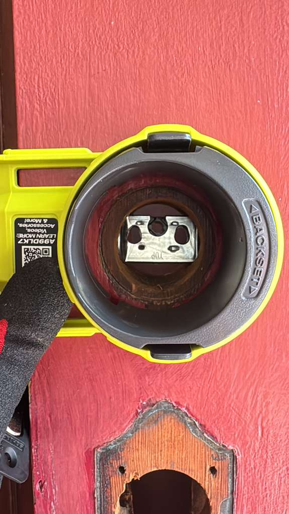 Yellow lock installation template guide on a residential door