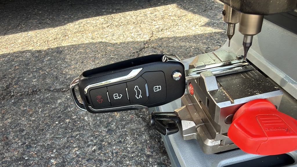 Car key fob being cut on a precision key-cutting machine