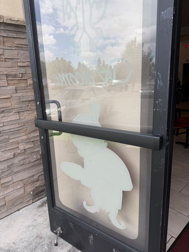Commercial glass door with panic bar and frosted graphic