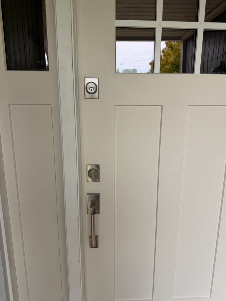 Brushed nickel deadbolt and handle set on a residential door