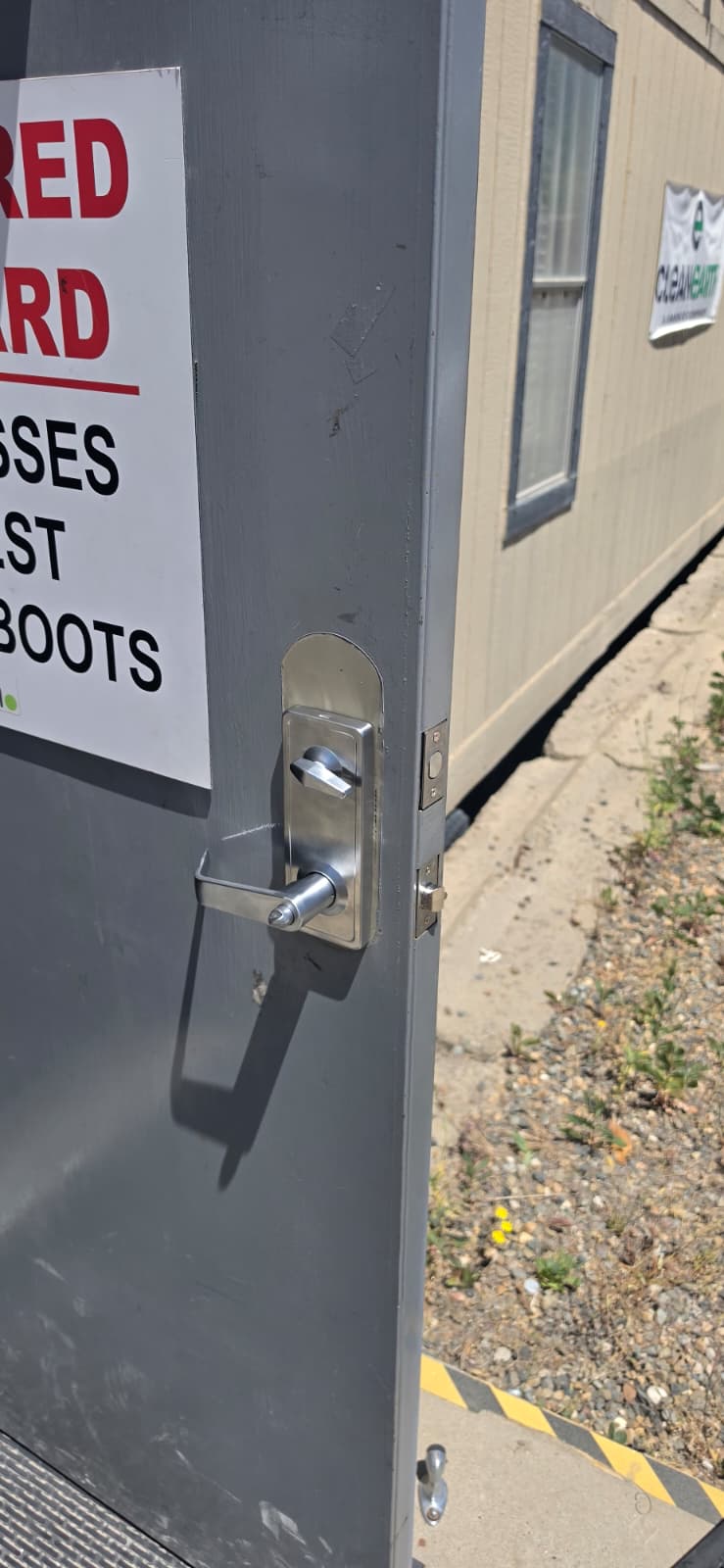 Commercial door handle and lever lock installation close-up