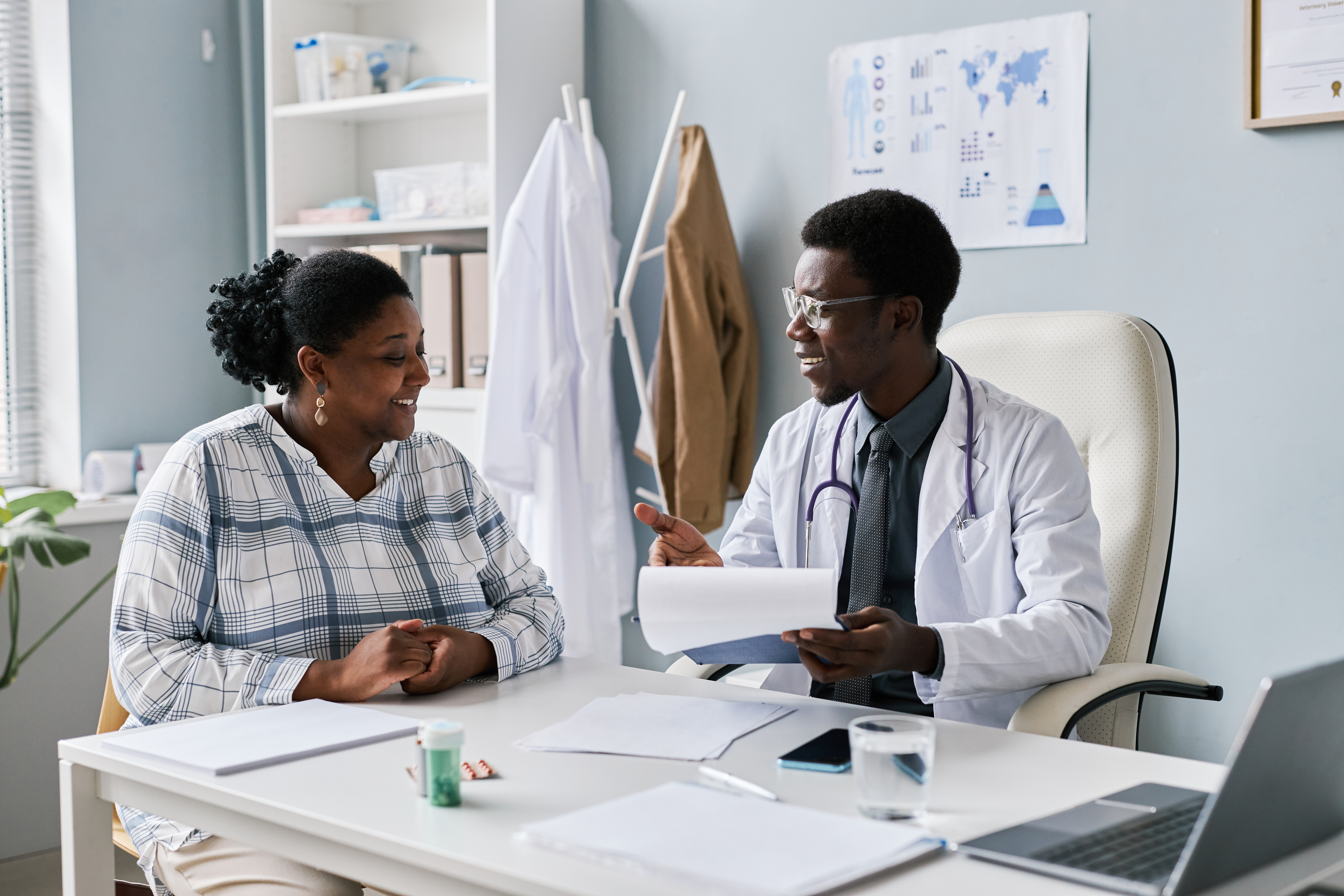 A clinician talking with a patient during a clinic visit
