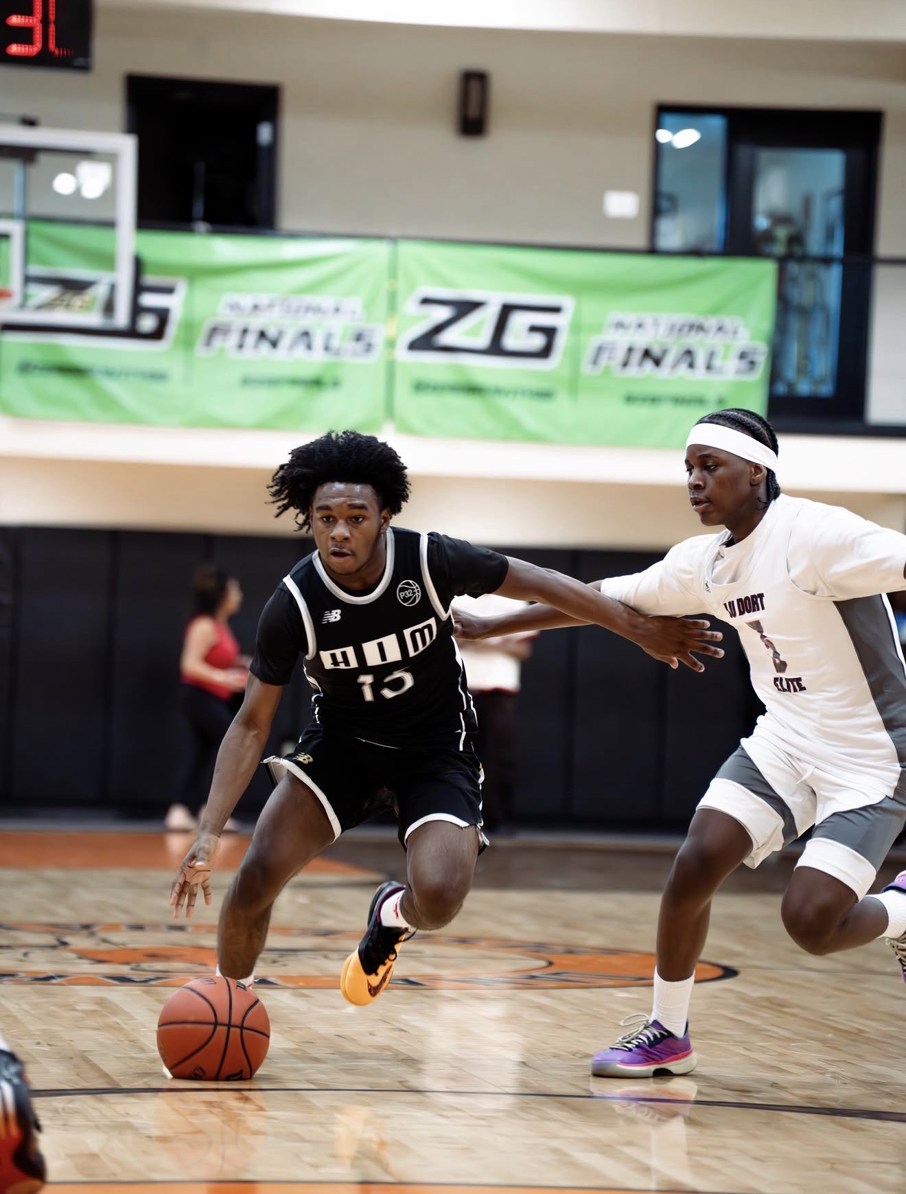 HIM League Basketball player dribbling in game action