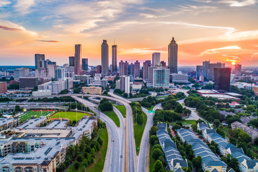 Atlanta skyline at sunset — sell your home with The Olusa Group