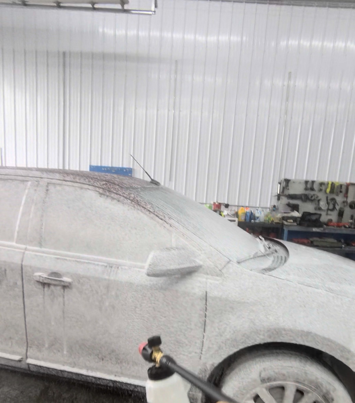 Snow foam pre-wash on a car in the detailing bay