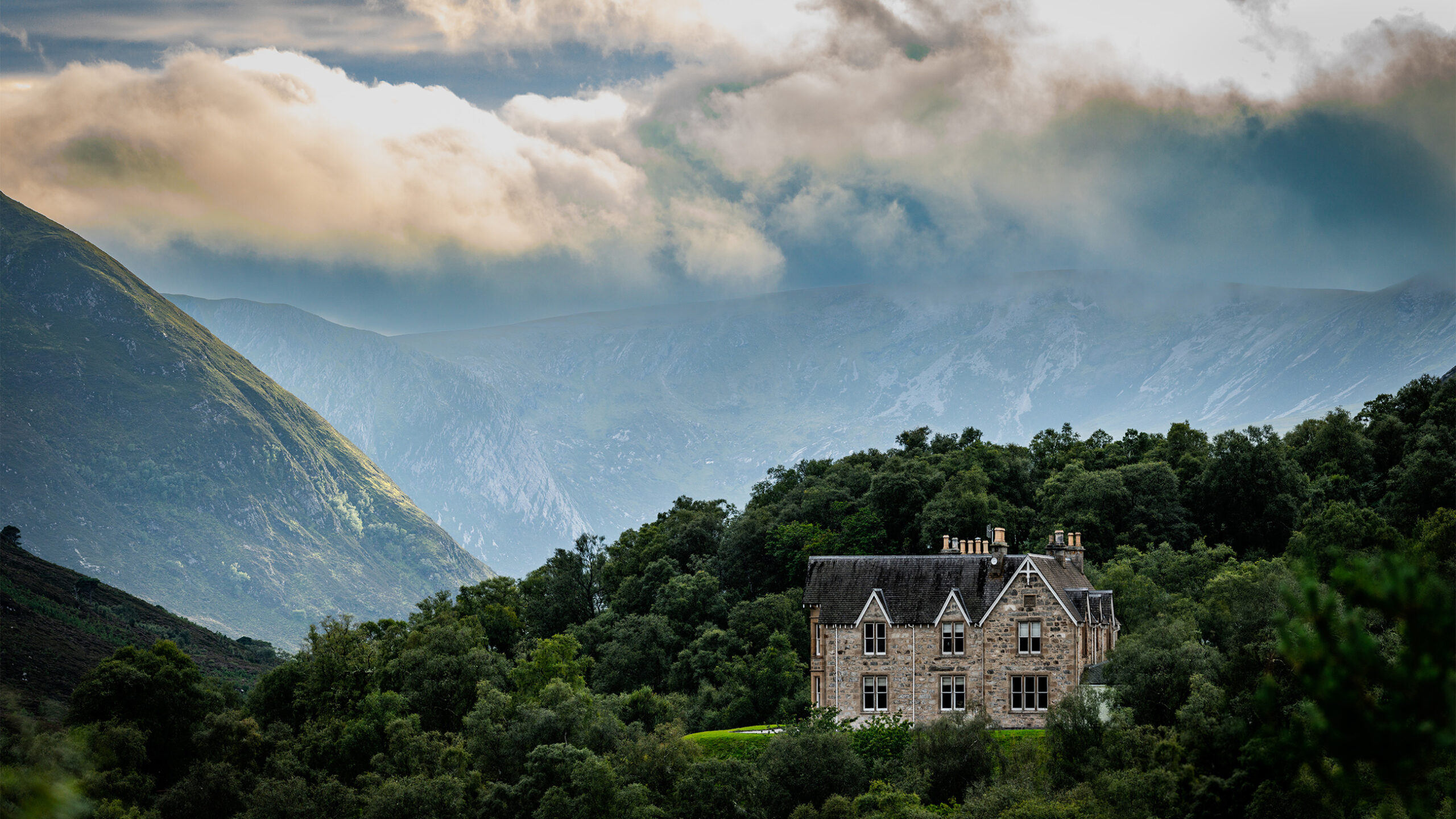 Alladale Lodge, a Victorian stone lodge set among trees in the glen