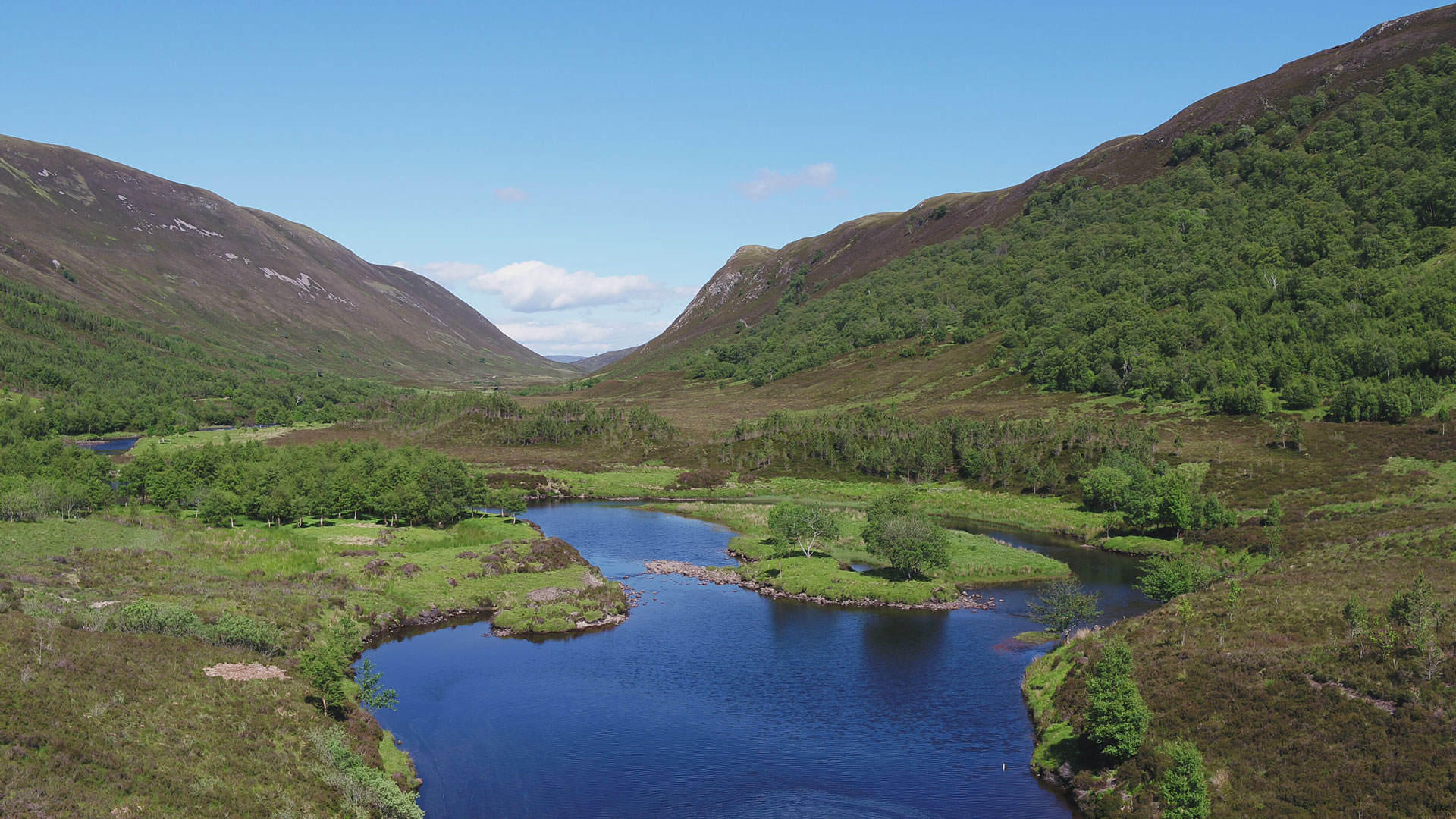 Loch and hills in Glen Mhòr, Alladale