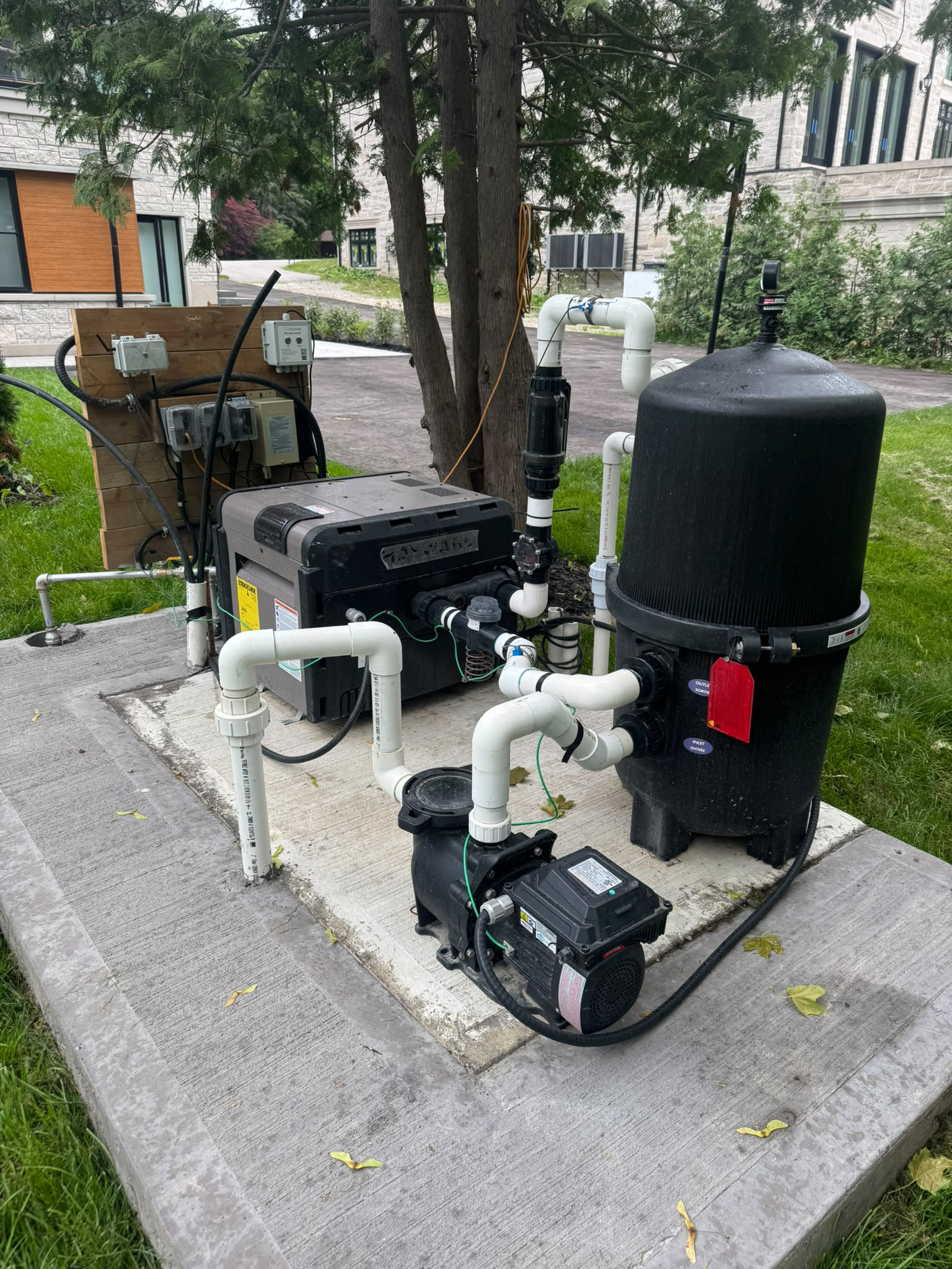 Pool pump, cartridge filter and heater installed on a residential equipment pad in King City, Ontario