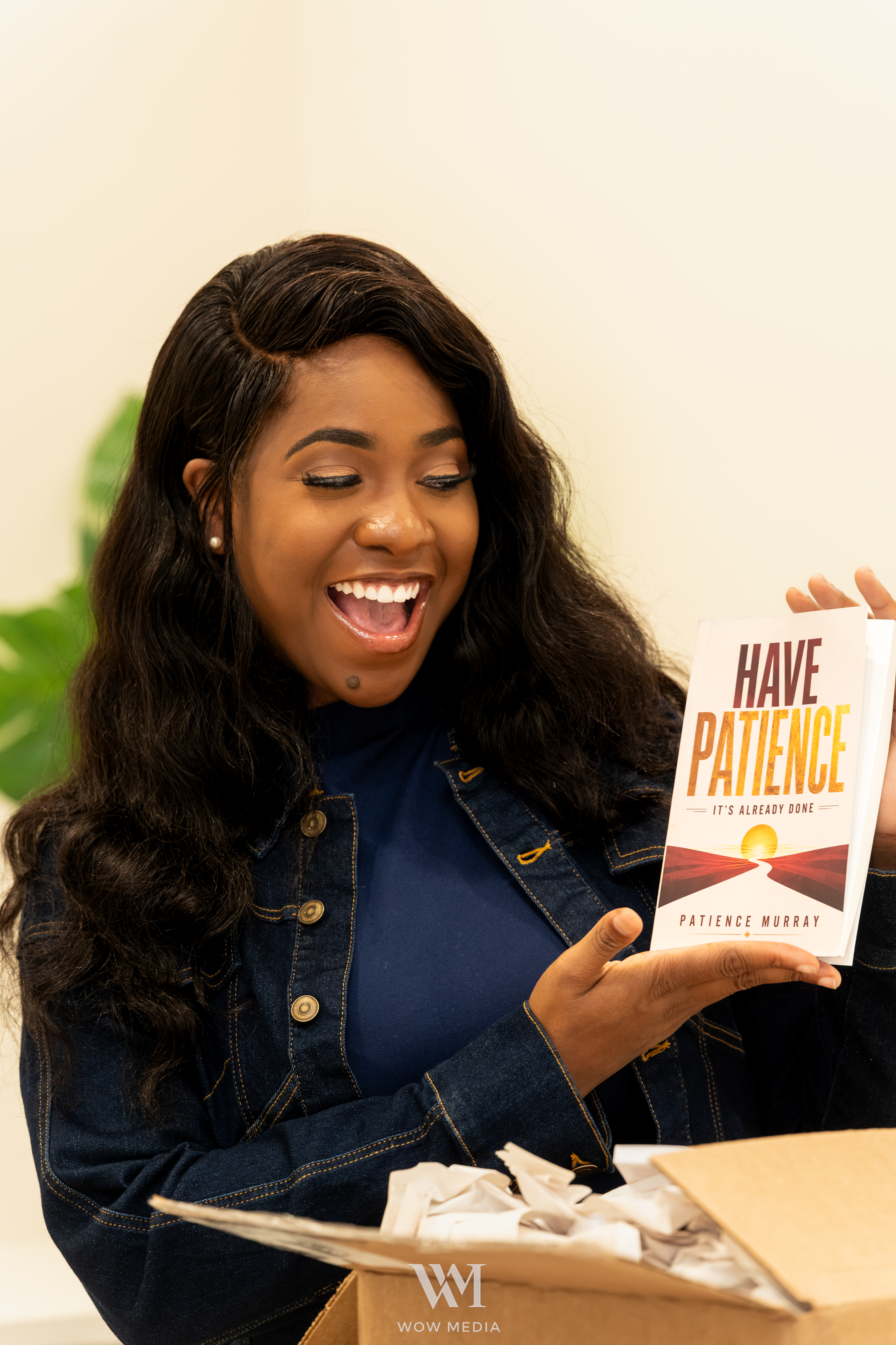 Patience Murray holding a copy of Have Patience: It's Already Done