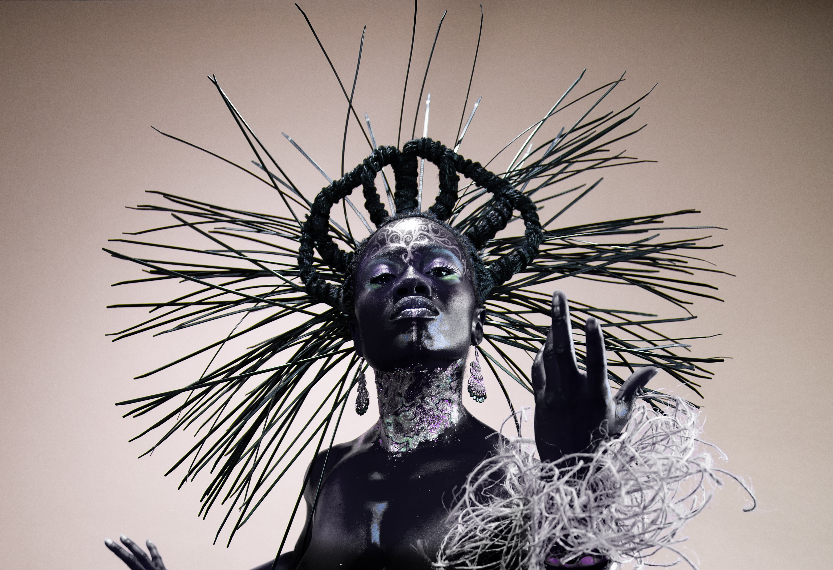 Untitled by Maurice Evans and Grace Kisa — a queen with a spiked crown and iridescent skin, hand raised in gesture