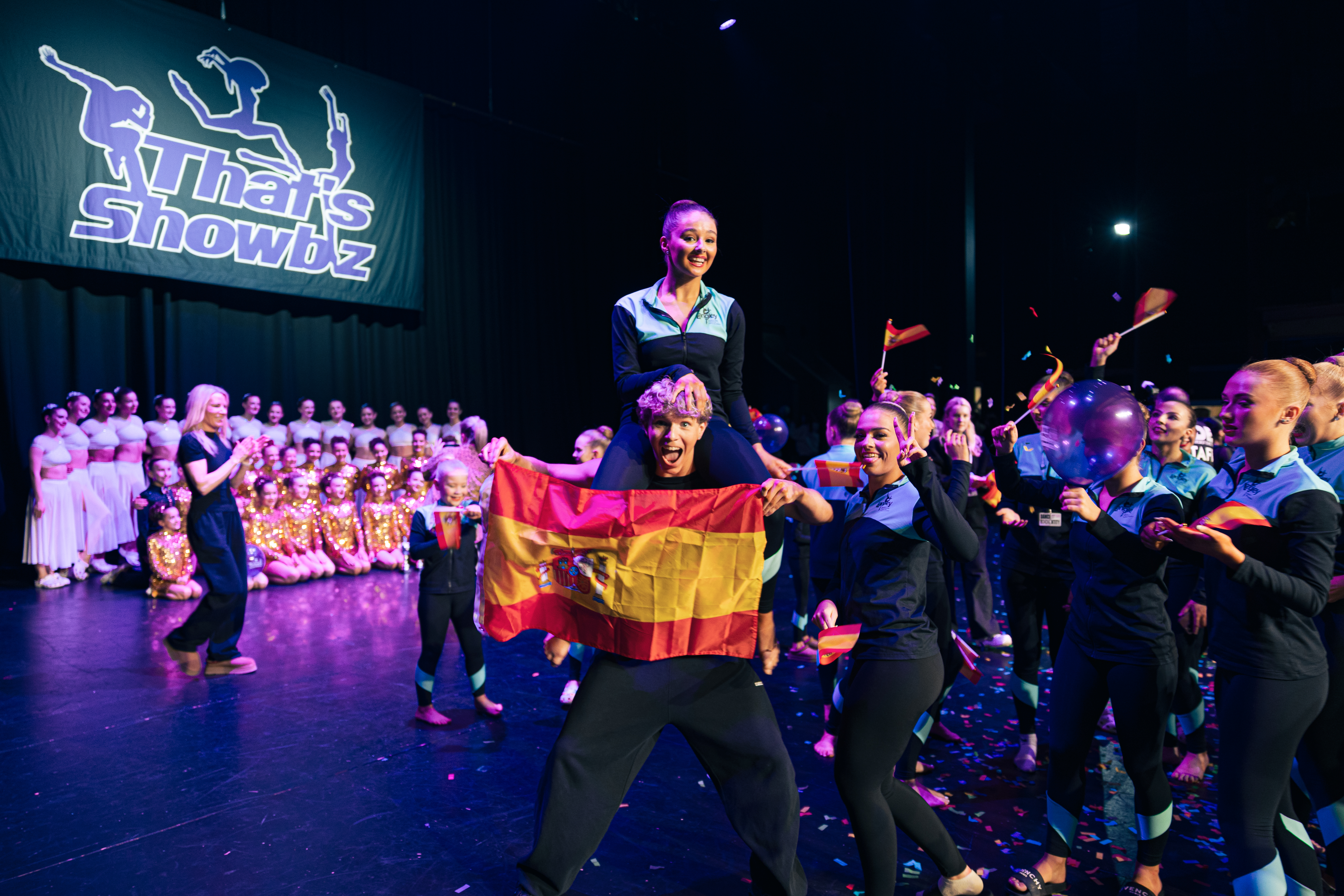 That's Showbiz International dancers celebrating on stage with the Spanish flag