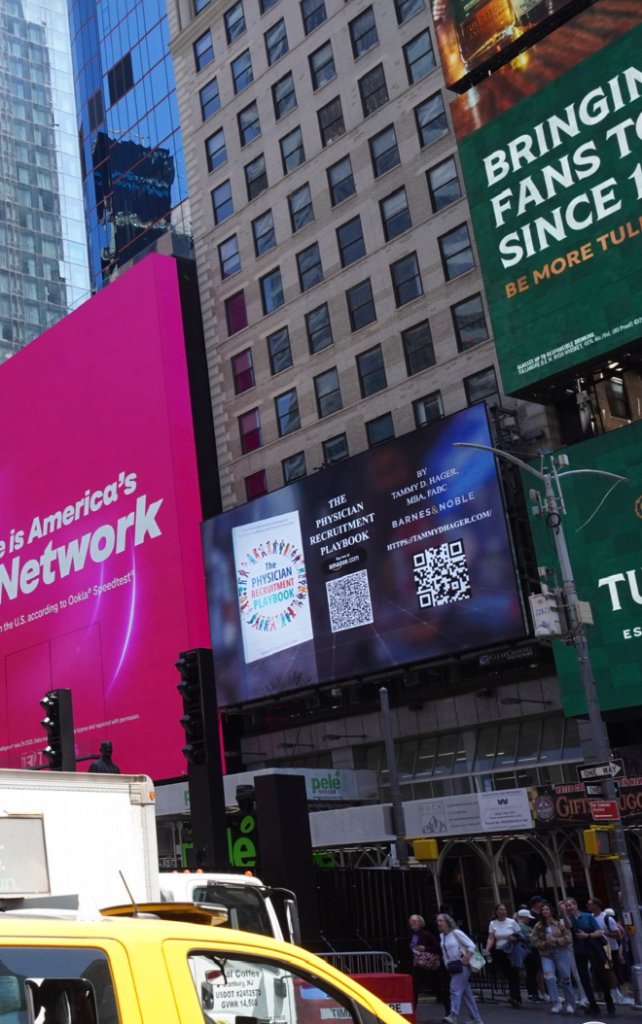 Street-level view of the Times Square billboard featuring the book — May 19, 2026