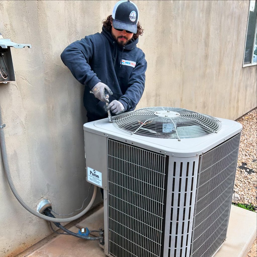 Core Comfort HVAC technician servicing a central HVAC condenser unit