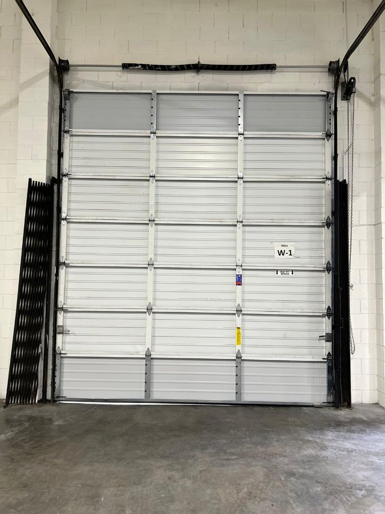 Garage door that has completely come off its tracks at Los Angeles residential home, emergency repair required