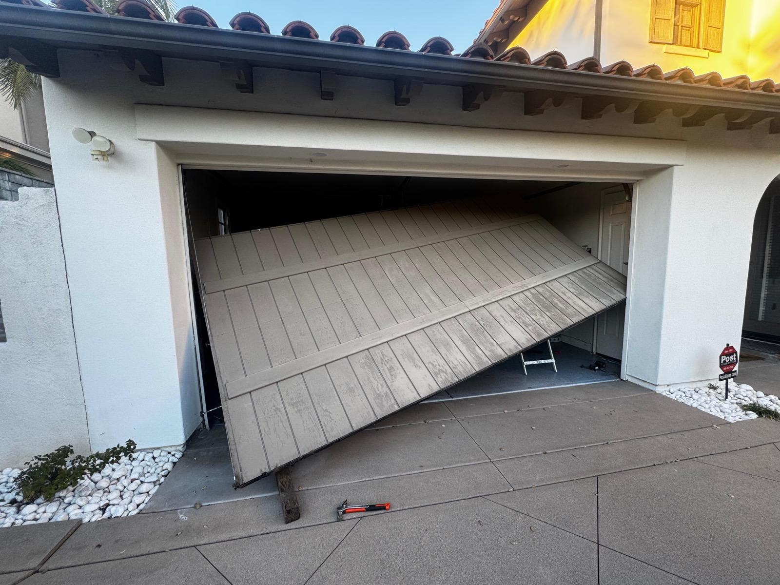 Residential garage door collapsed off its tracks at a Spanish-style Los Angeles home, emergency off-track repair by MSB