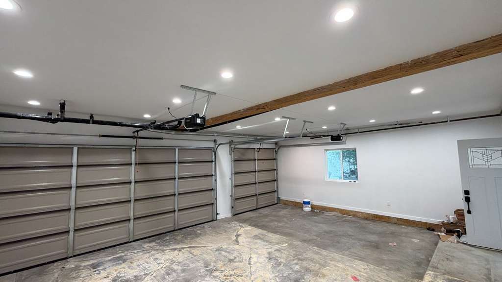Garage door opener inspection Los Angeles Interior garage inspection showing opener motor, rail and LED lighting condition during safety check