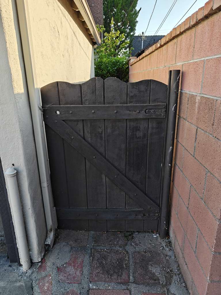 Dark wooden pedestrian gate repaired by MSB Garage Door Repair at Los Angeles residential property