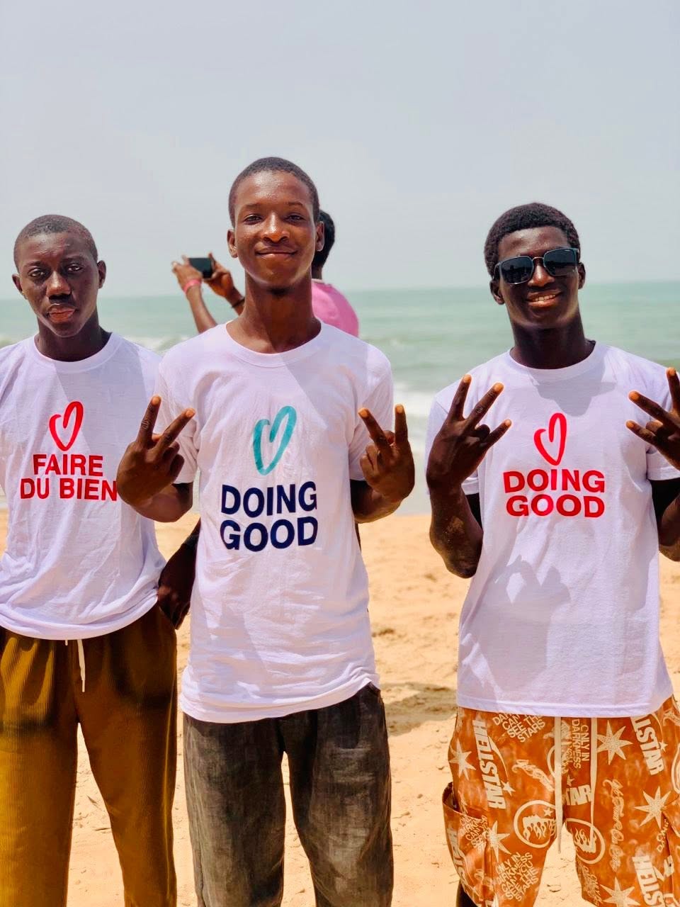 Youth pointing together on the beach