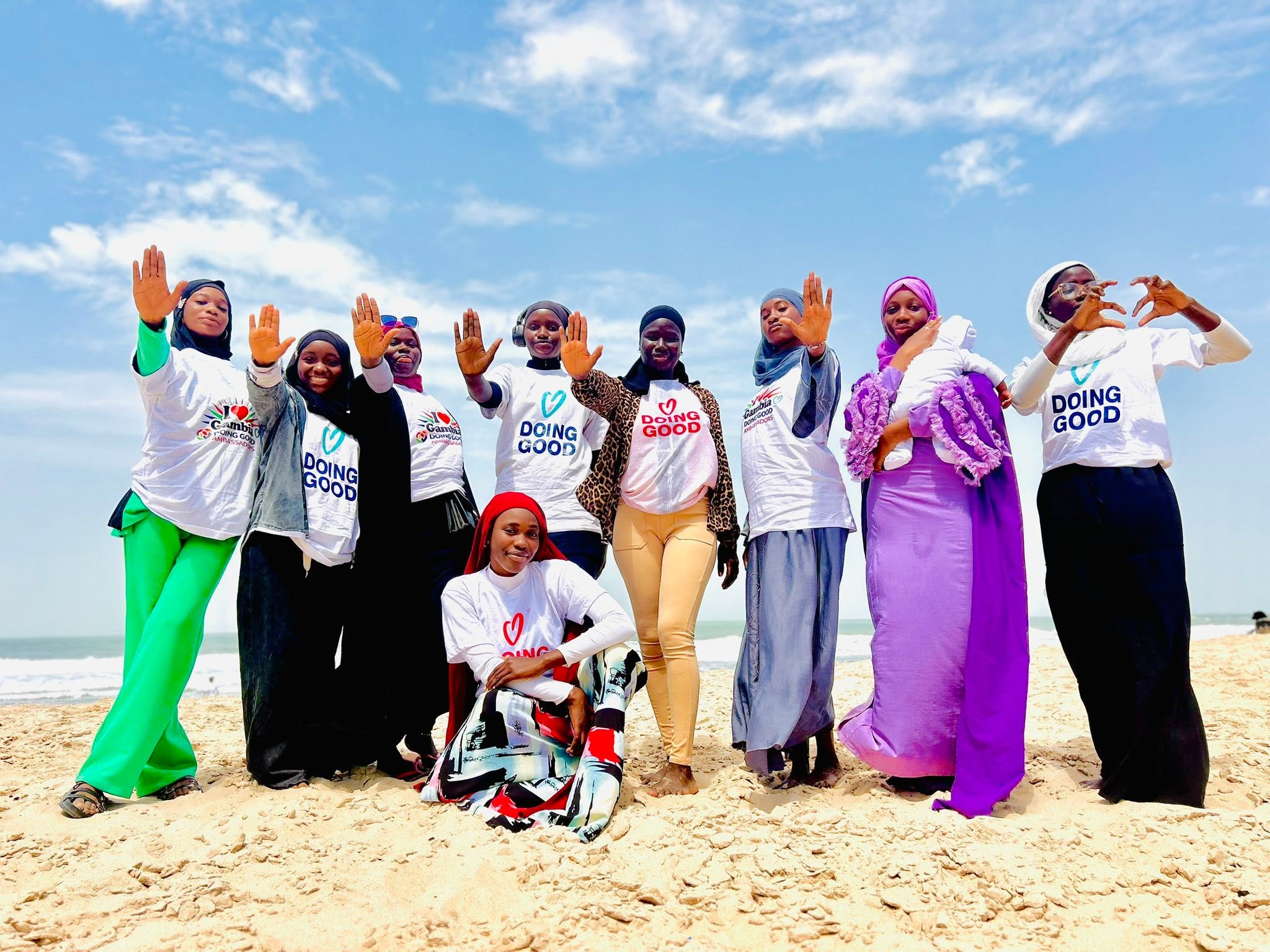 Ambassadors waving at the beach