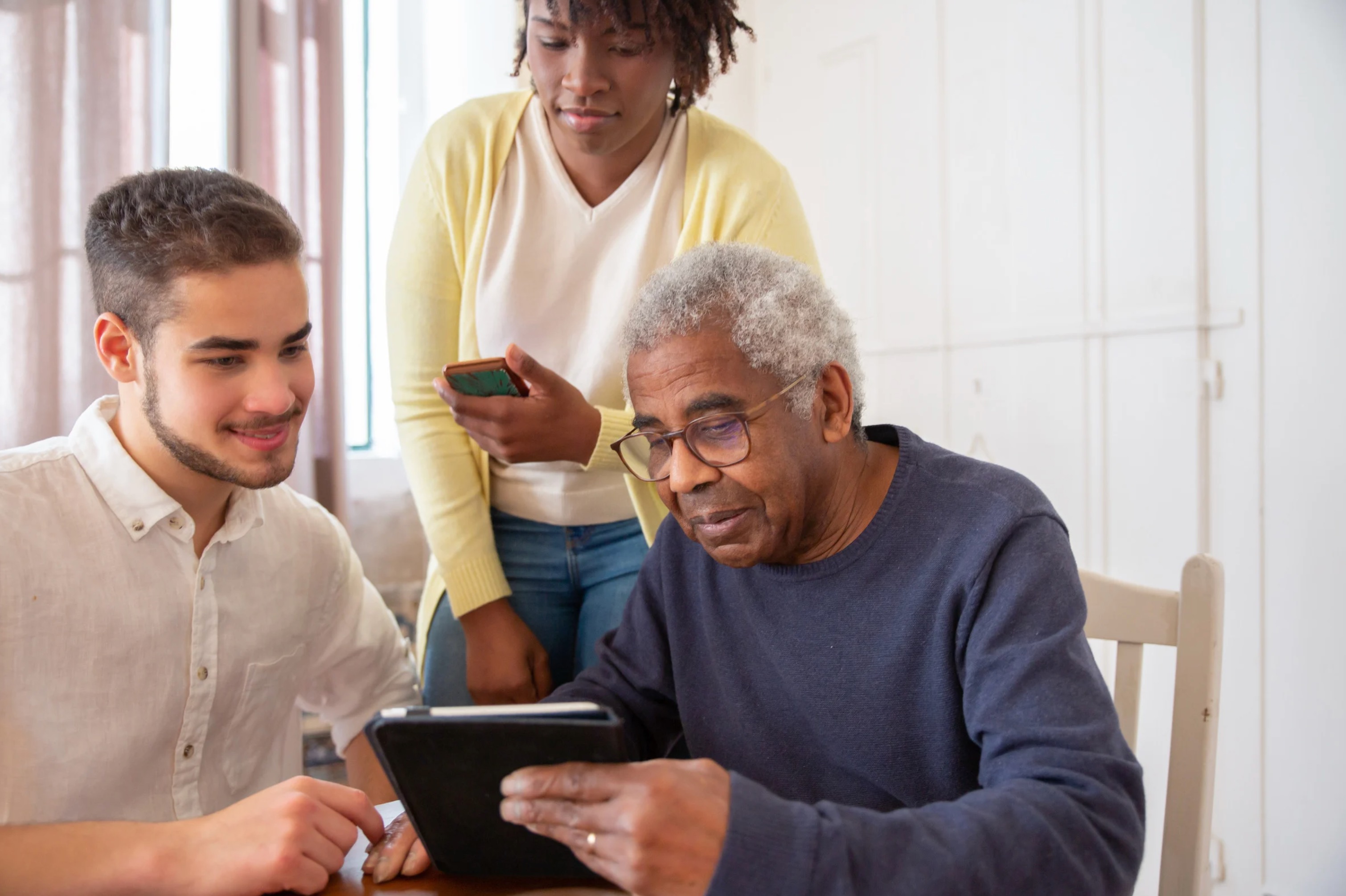 Caregiver helping senior with a tablet